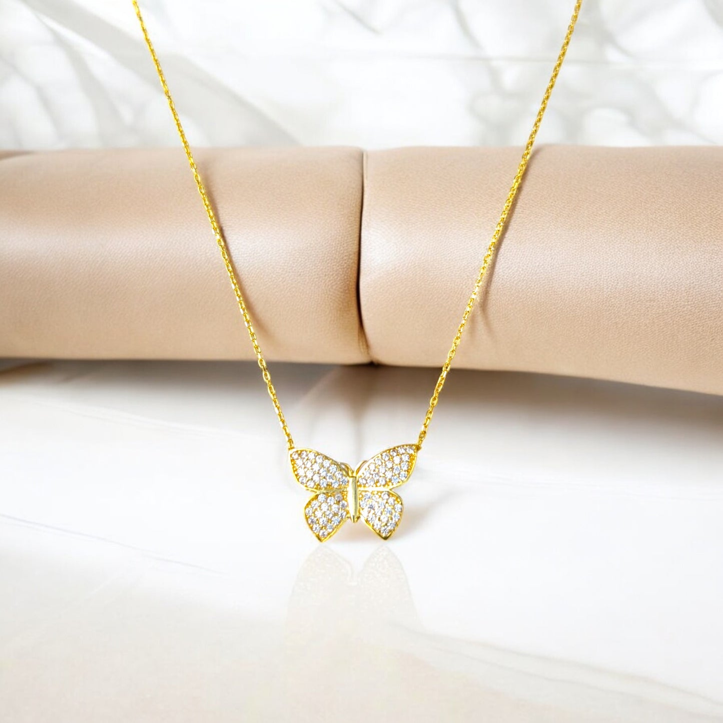 18K yellow gold butterfly necklace with clear stones.