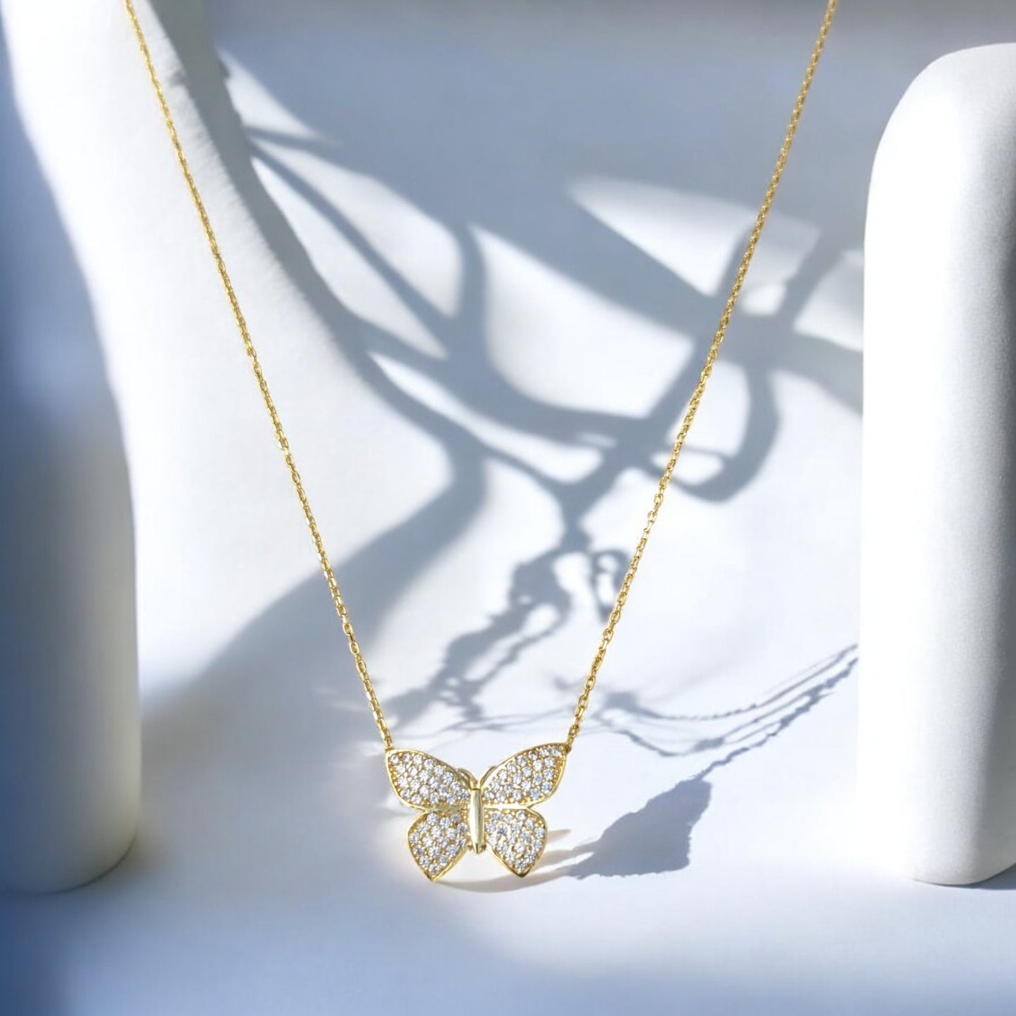 18K yellow gold butterfly necklace with clear stones.