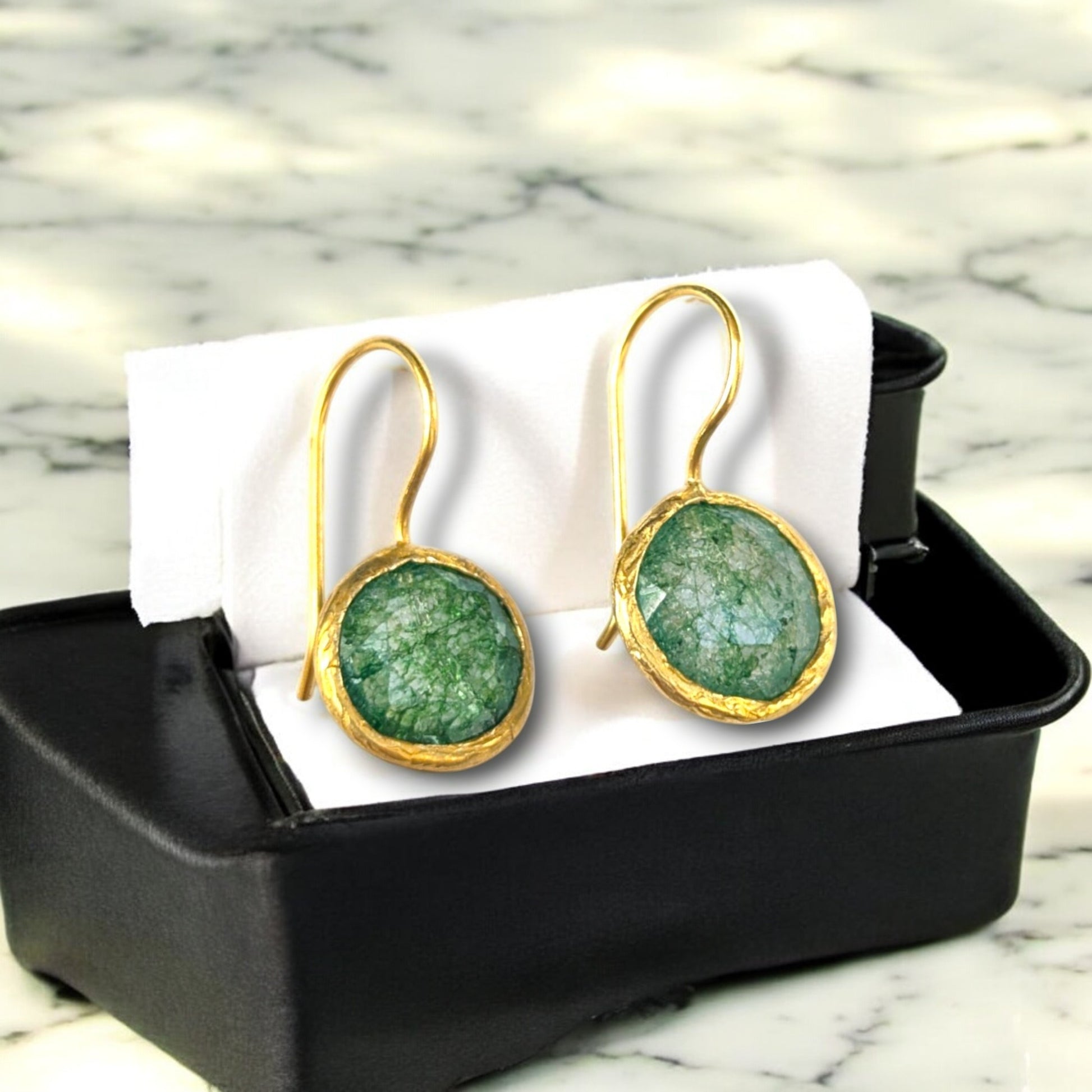 Green fusion stone drop earrings with gold bezels and hook ear wires.