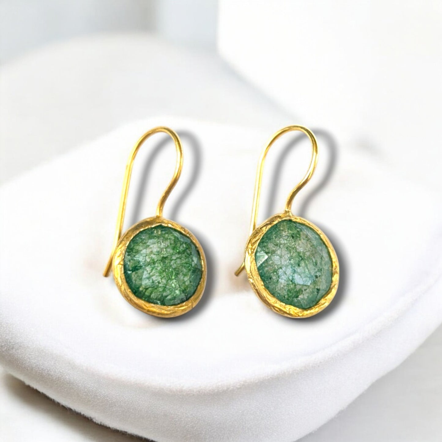 Green fusion stone drop earrings with gold bezels and hook ear wires.