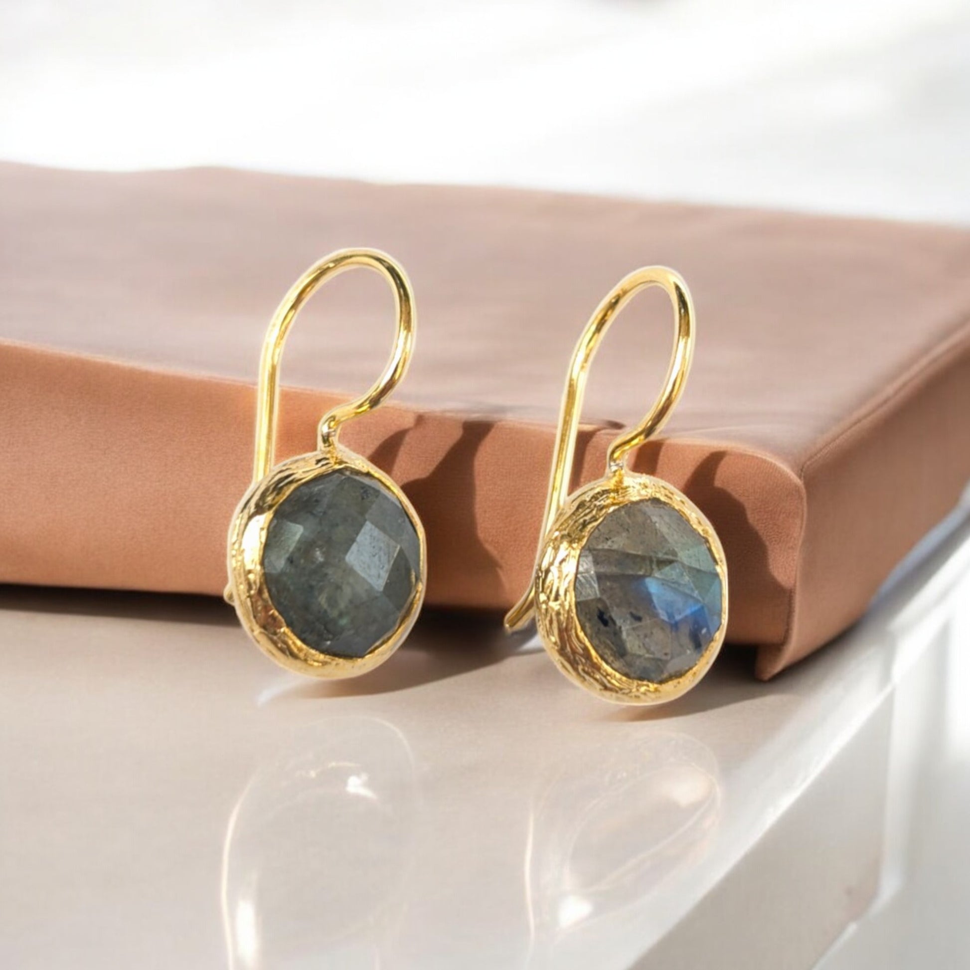 Labradorite drop earrings with gold-toned bezels and iridescent stones."