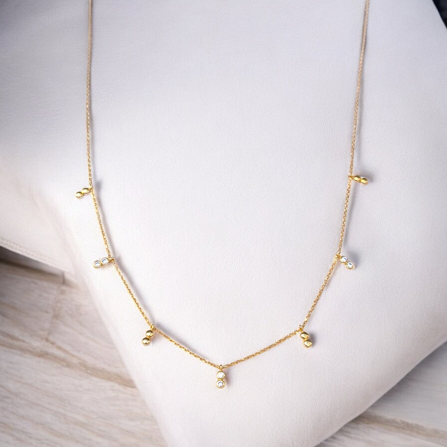 Delicate gold necklace with bezel-set CZ accents