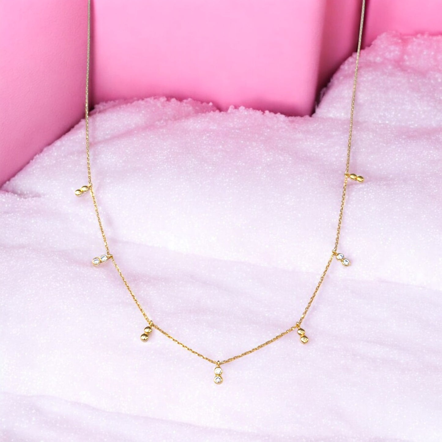 Delicate gold necklace with bezel-set CZ accents