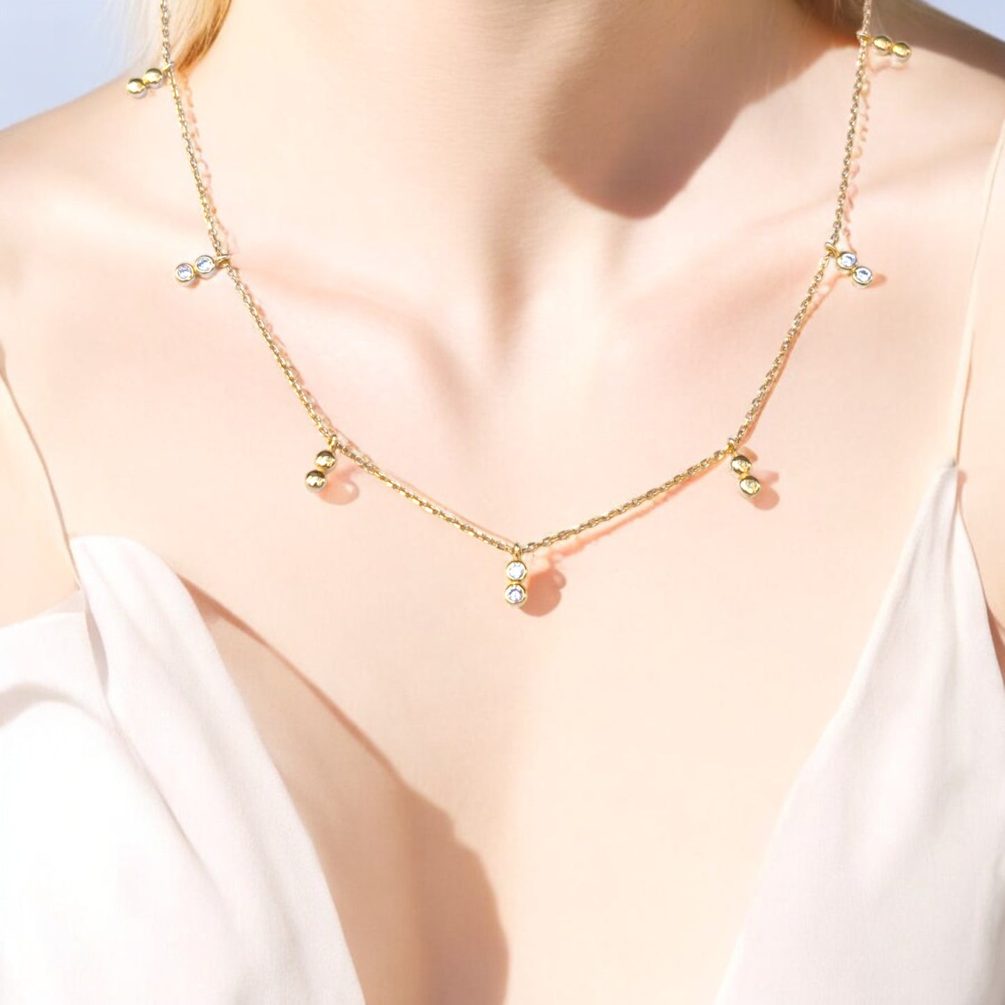 Delicate gold necklace with bezel-set CZ accents