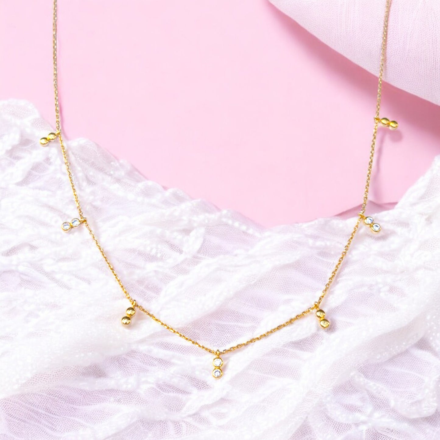 Delicate gold necklace with bezel-set CZ accents