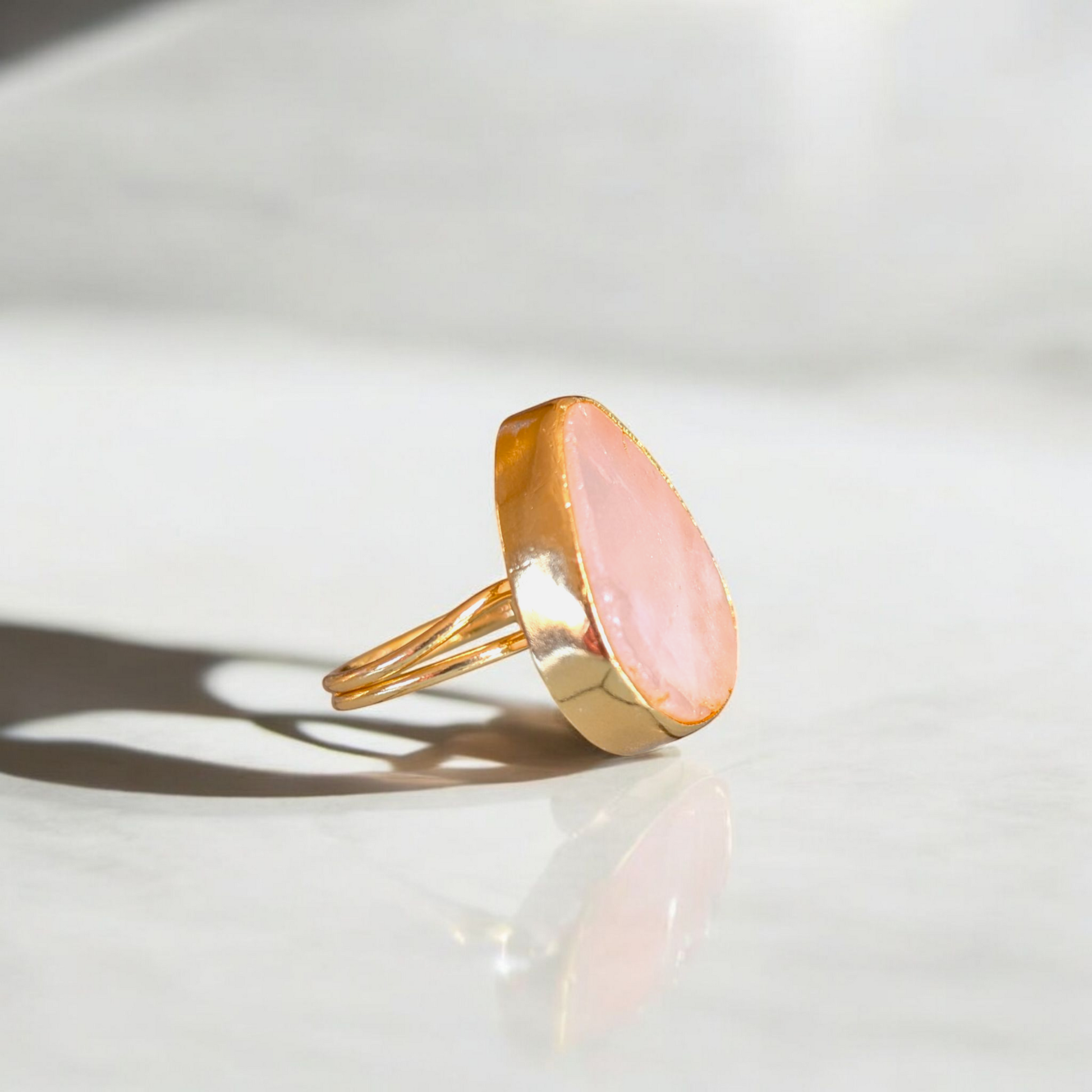 Teardrop rose quartz ring with gold bezel and double band