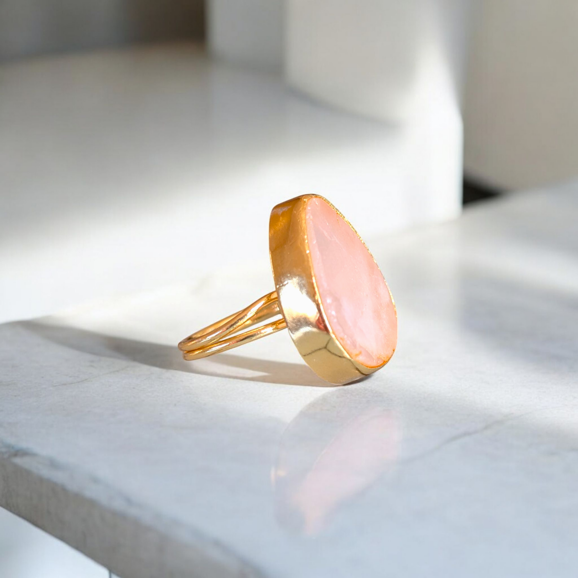 Teardrop rose quartz ring with gold bezel and double band
