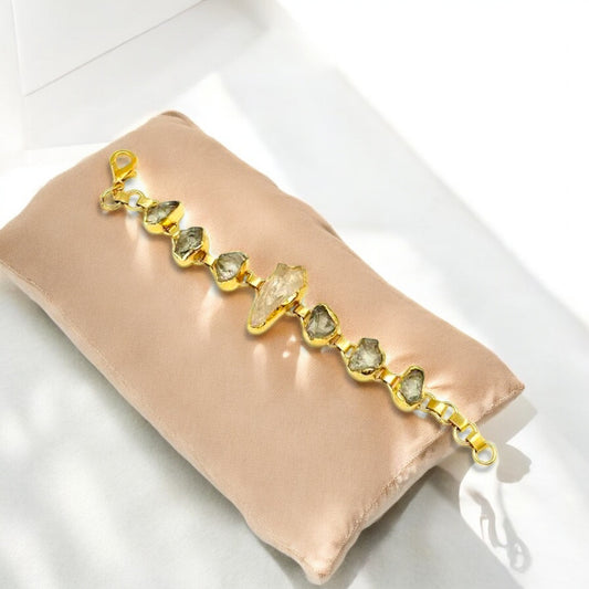 Raw green amethyst and clear quartz bracelet with gold plating .