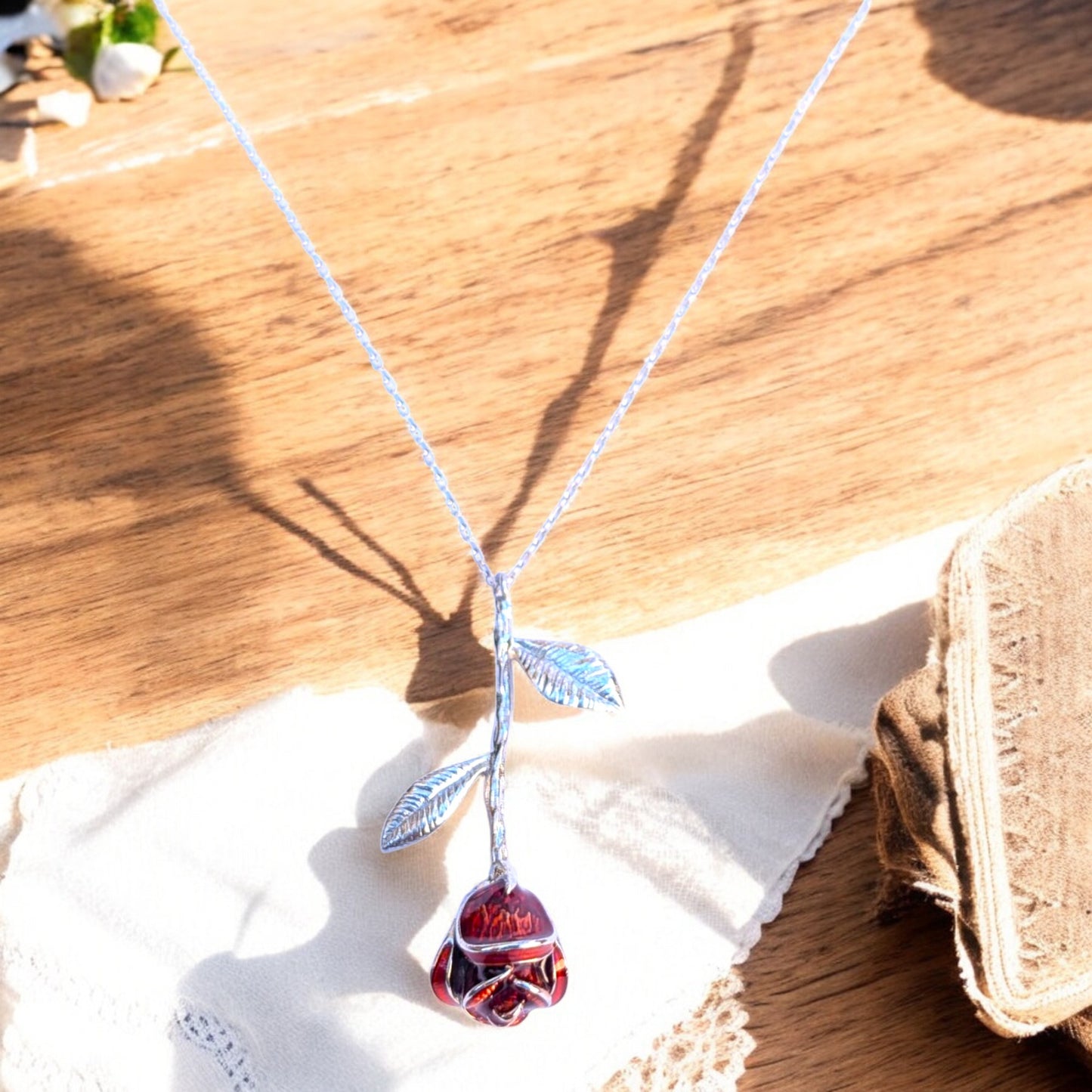 Delicate rose pendant necklace with red enamel bloom and silver chain