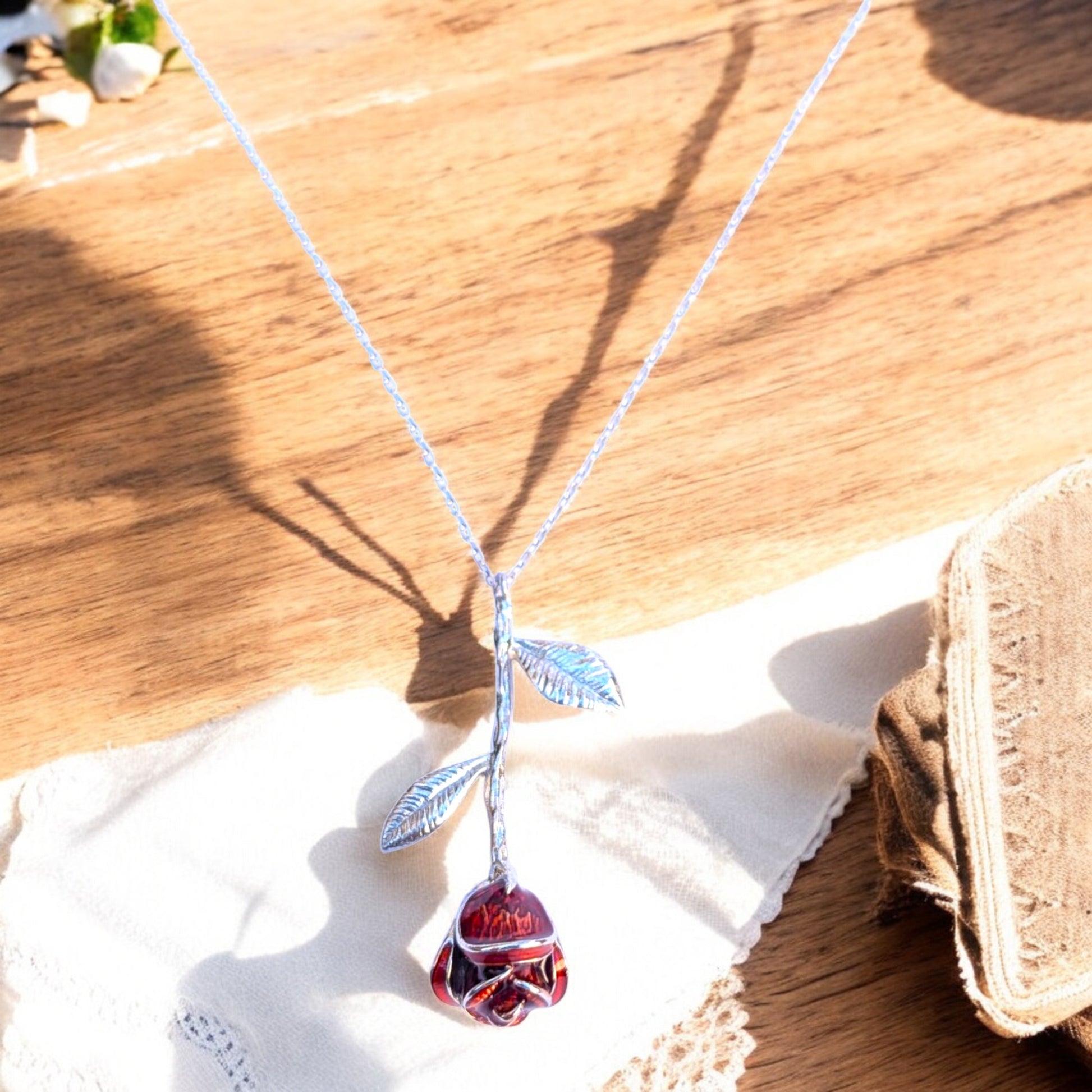 Delicate rose pendant necklace with red enamel bloom and silver chain