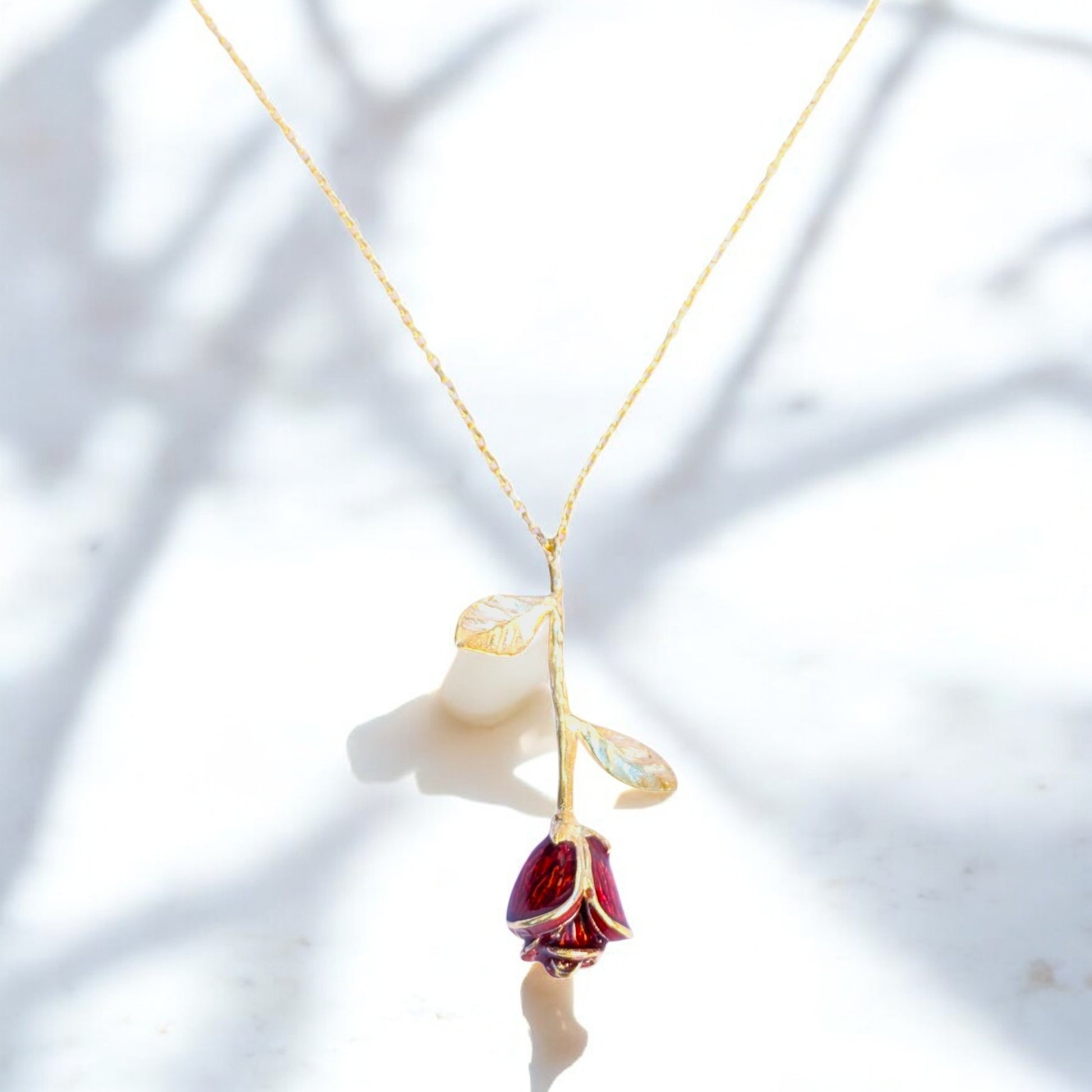 Delicate rose pendant necklace with red enamel bloom and silver chain