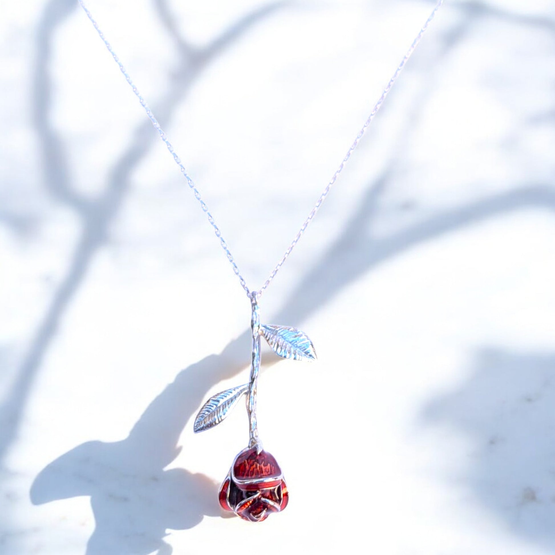 Delicate rose pendant necklace with red enamel bloom and silver chain