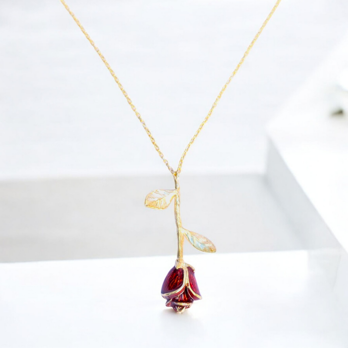 Delicate rose pendant necklace with red enamel bloom and silver chain