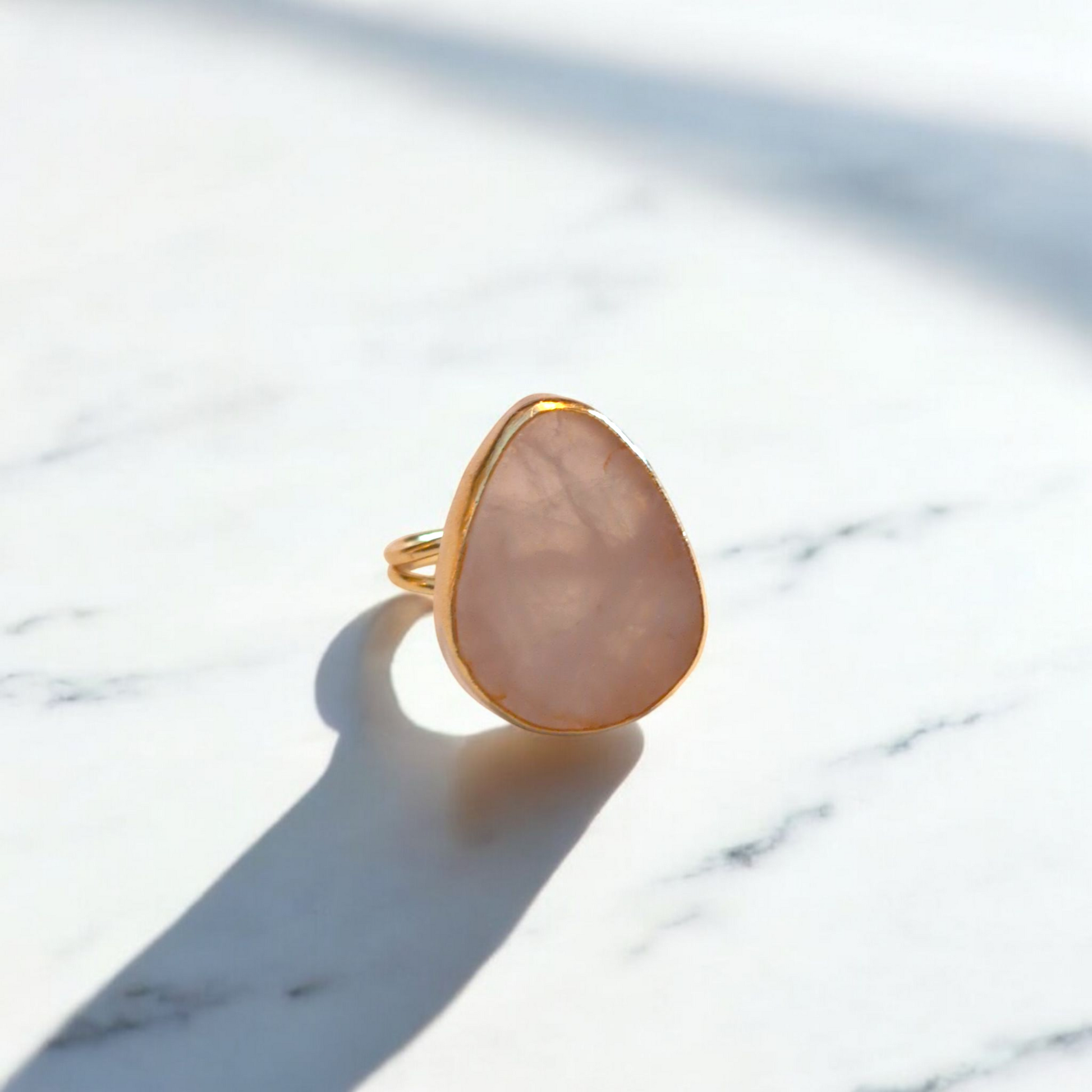 Teardrop rose quartz ring with gold bezel and double band