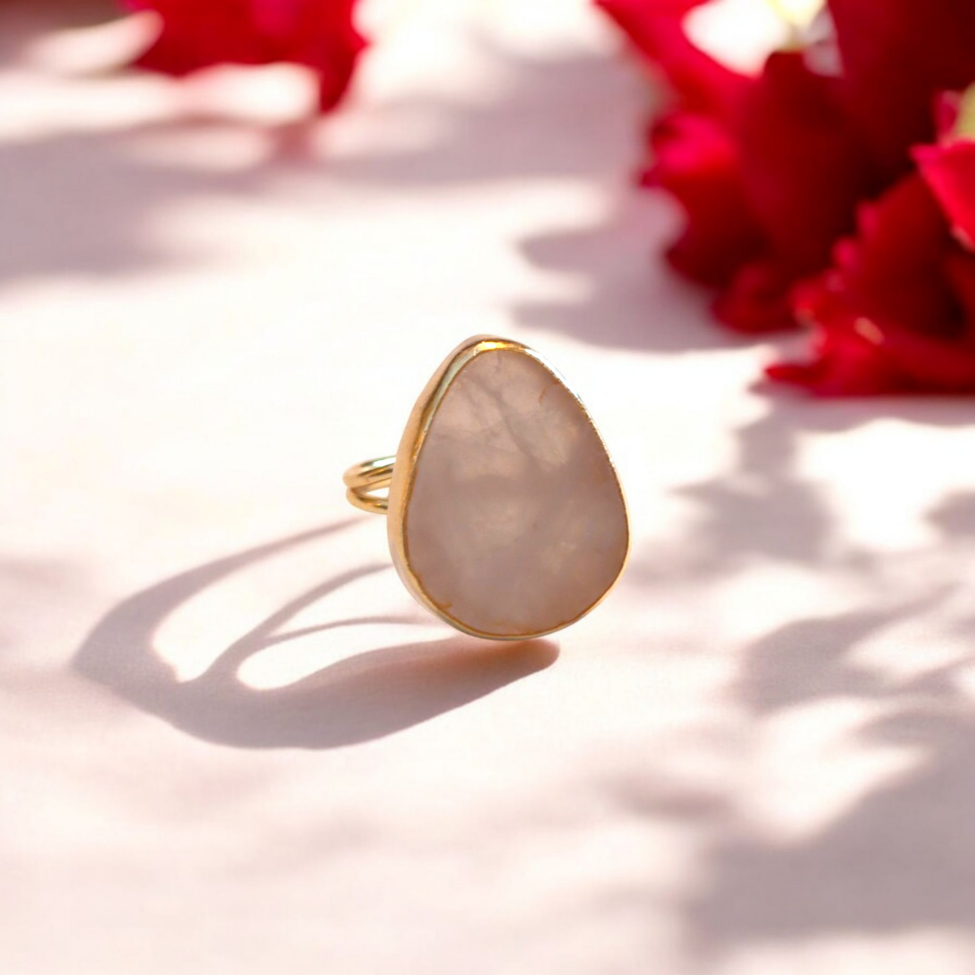 Teardrop rose quartz ring with gold bezel and double band