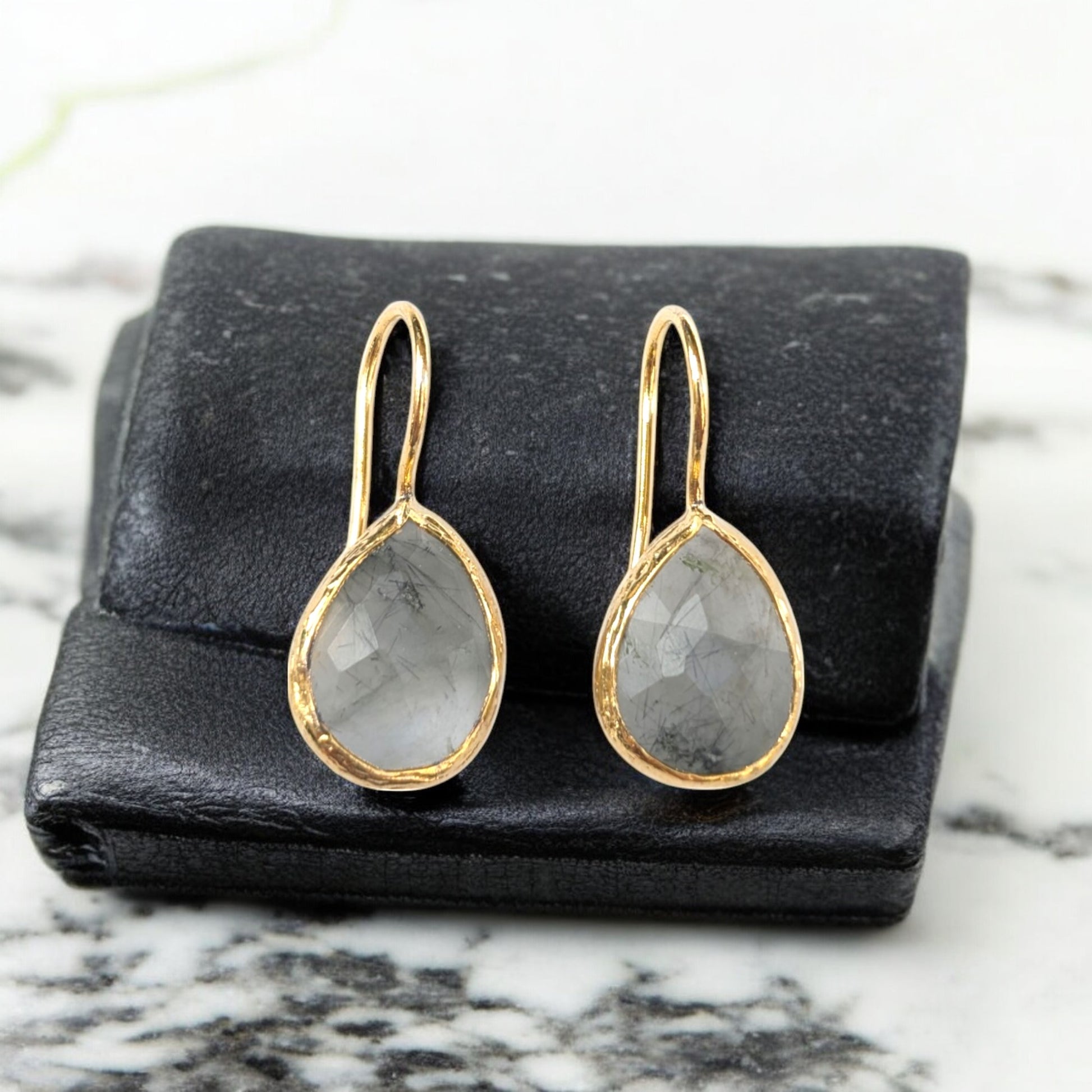 Handmade teardrop Rutilated quartz earrings with gold bezel trim.