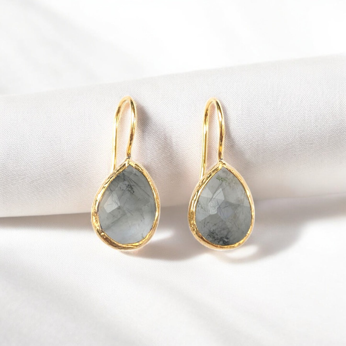Handmade teardrop Rutilated quartz earrings with gold bezel trim.