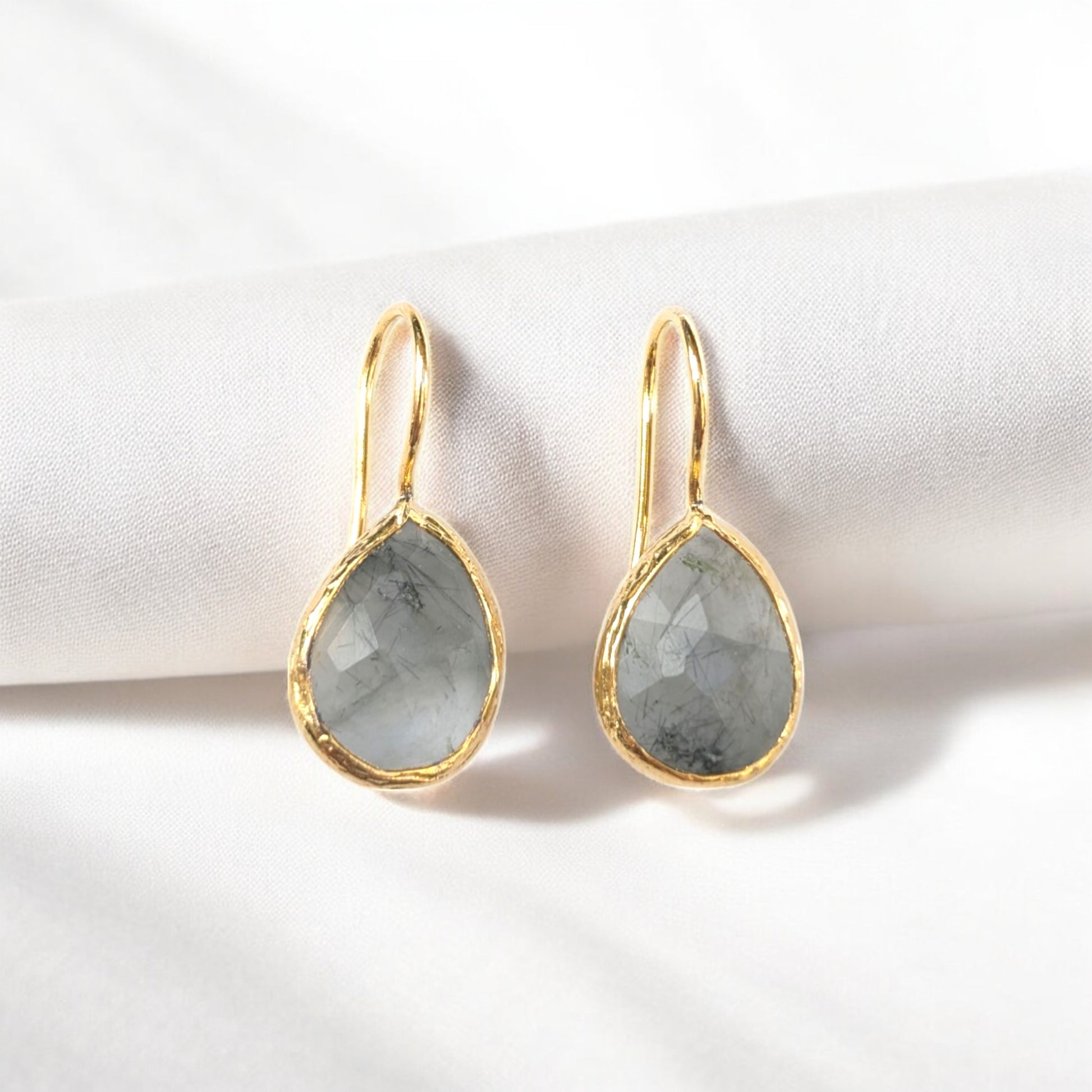 Handmade teardrop Rutilated quartz earrings with gold bezel trim.